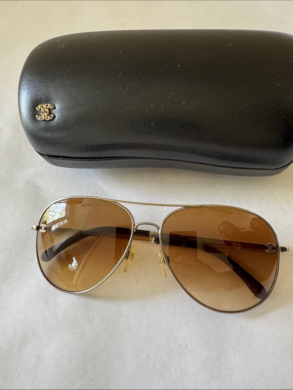 Chanel aviator sunglasses with light brown lens and hard case.